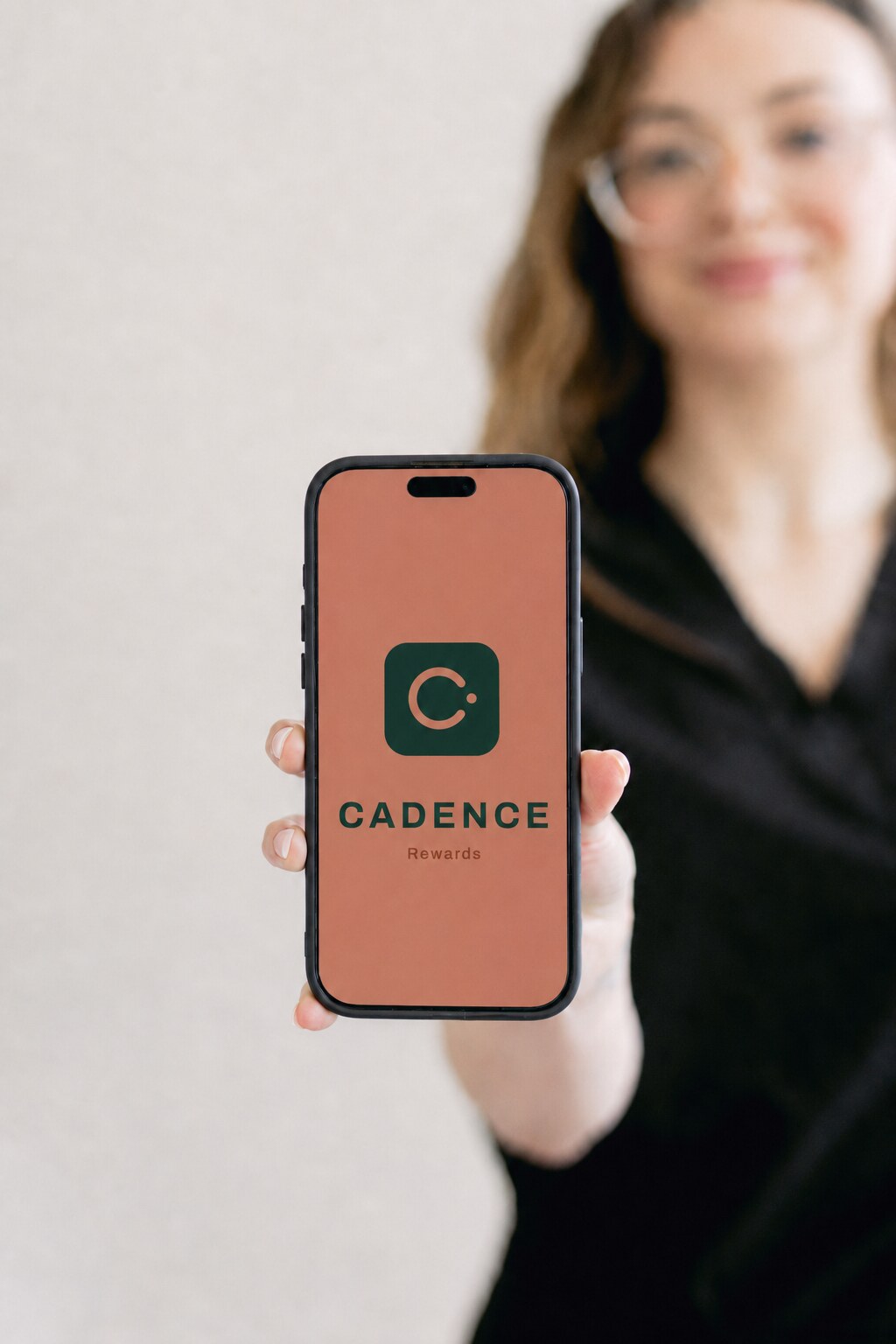 Phone mockup of a practice's white-label Cadence rewards and membership app